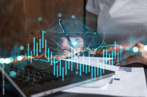 Woman signs agreement. Forex financil market chart and graph hologram. Double exposure . Brokerage concept. photo