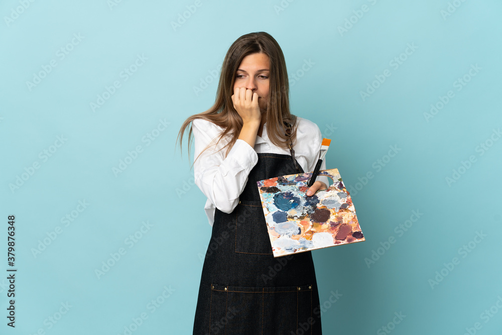 Young artist Slovak woman isolated on blue background having doubts Young artist Slovak woman isolated on blue background having doubts