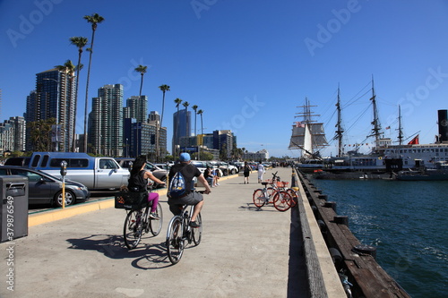 People are walking and bike ride along the walkway of San Diego Bay California, USA