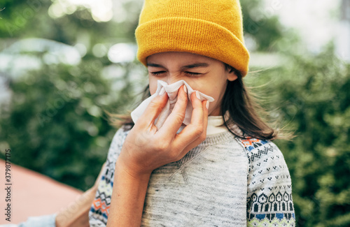 Photography Outdoor portrait of a little girl sneezing the nose into the tissue