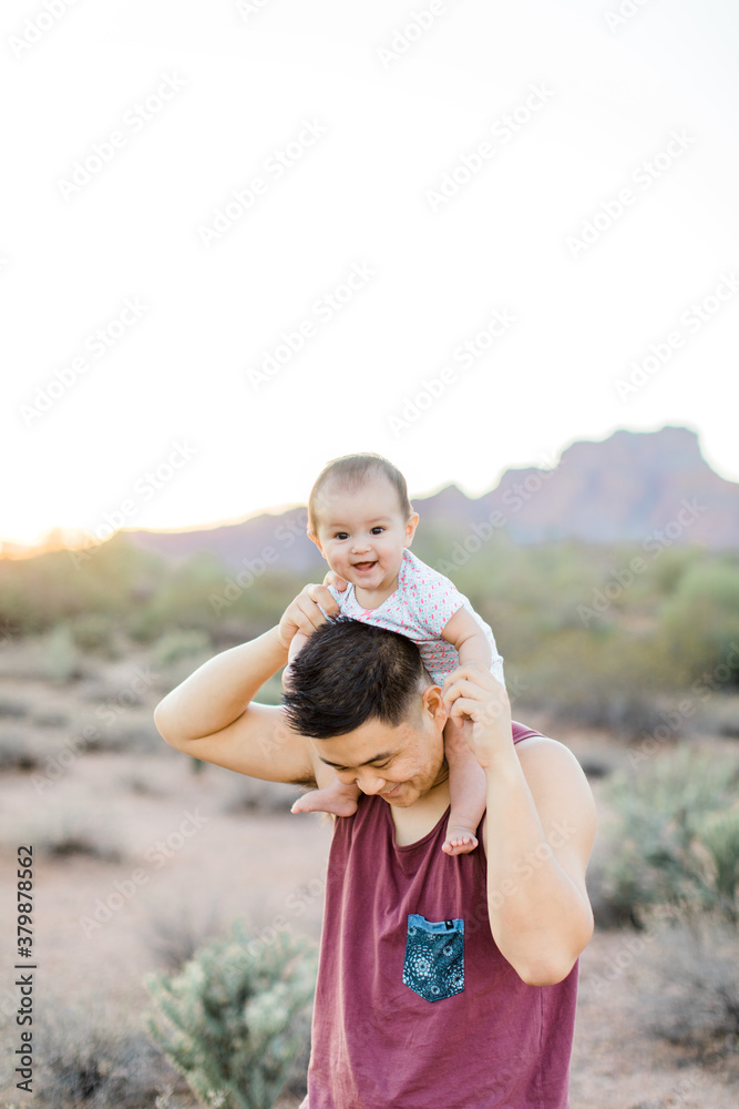 Happy baby sitting on dads shoulders Happy baby sitting on dads shoulders