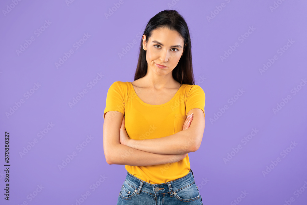 Portrait of offended woman standing with folded arms Portrait of offended woman standing with folded arms