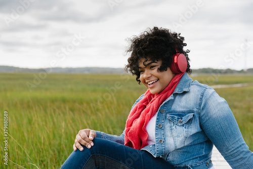 Hispanic Girl Listenting to music on Headphones photo