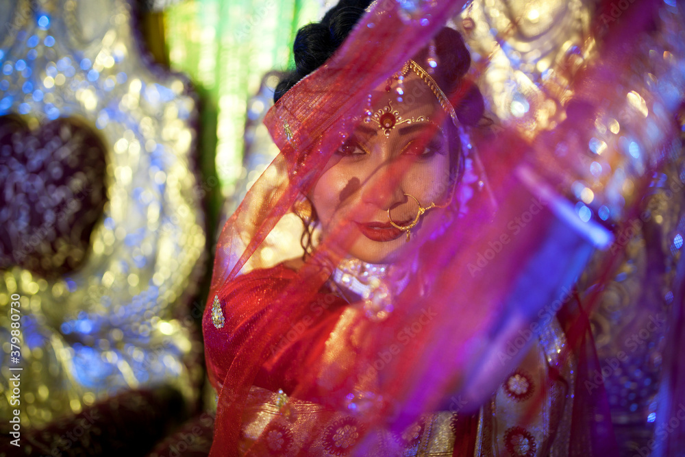 A newly married bride hides her face behingd Dupatta A newly married bride hides her face behingd Dupatta