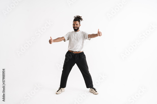 Photo of joyful african american guy showing thumbs up