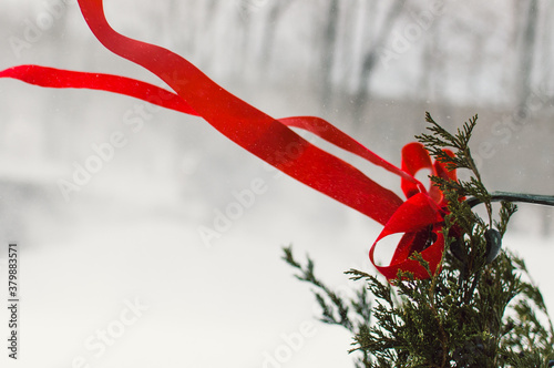 red ribbon on Christmas wreath blowing in snow photo