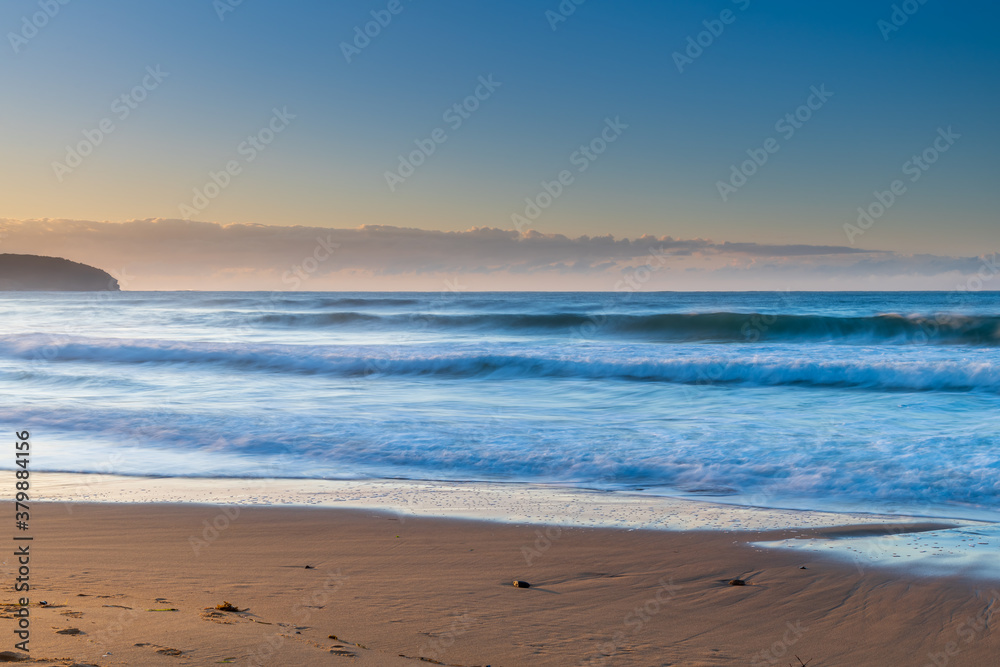 Clear skies winter sunrise seascape with fog on the horizon