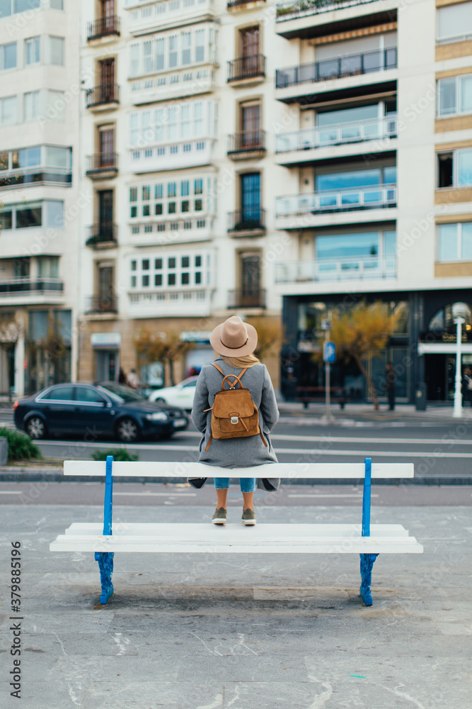 woman on the bench looking to the street woman on the bench looking to the street