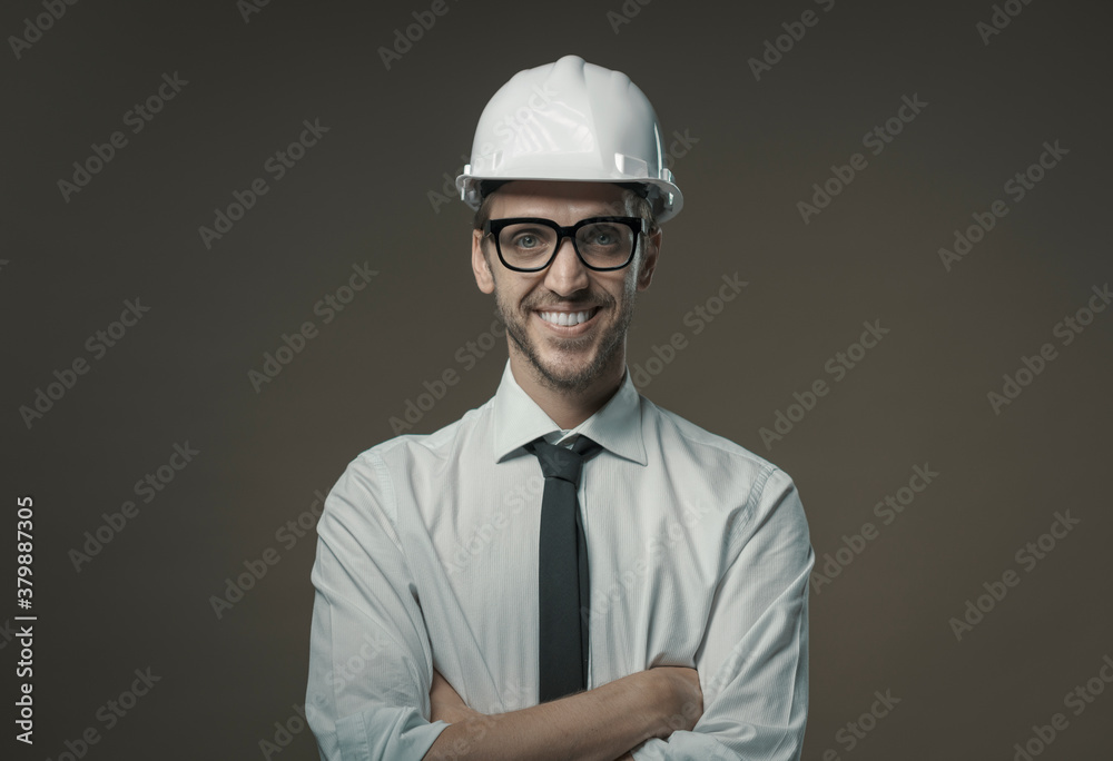 Confident architect smiling and wearing a safety helmet
