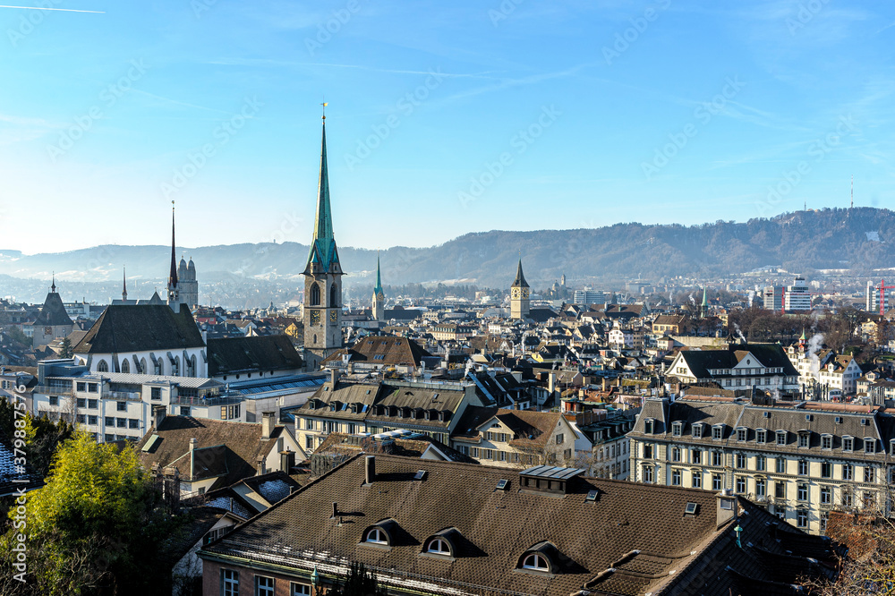 morning view of the city of Zurich in Switzerland. Numerous bell towers and morning mist in the distance.