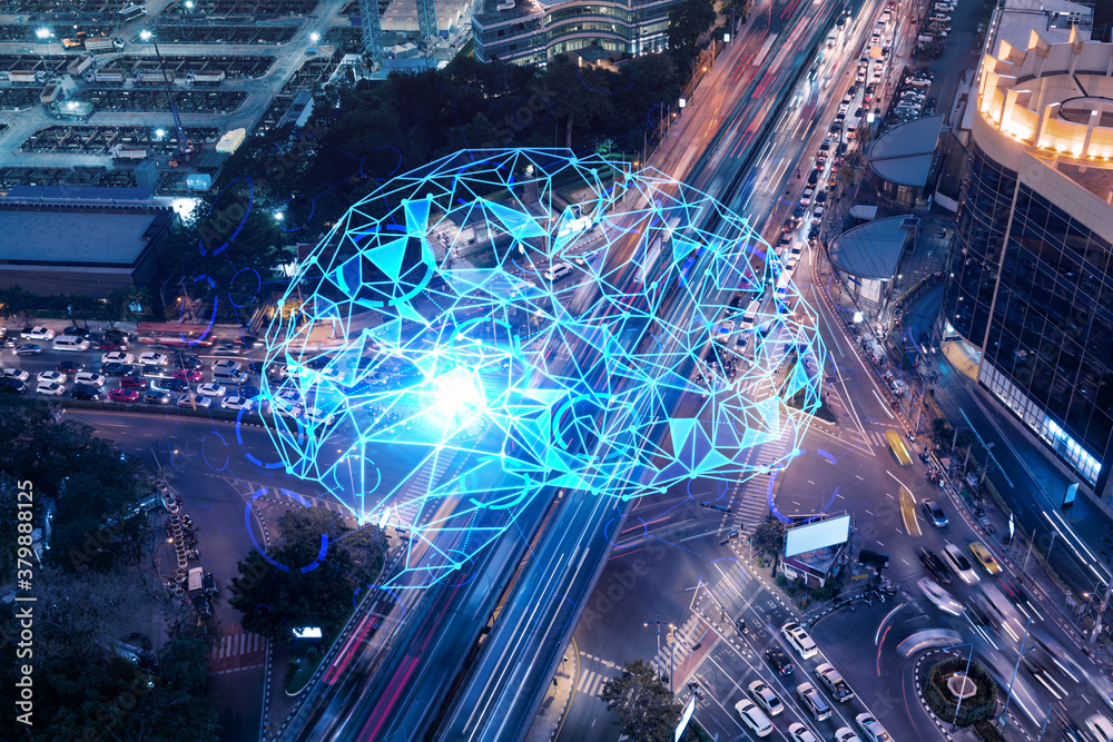 Brain hologram on aerial view of road, busy urban traffic highway at night. Junction network of transportation infrastructure. The concept of developing coding and high-tech in logistics.