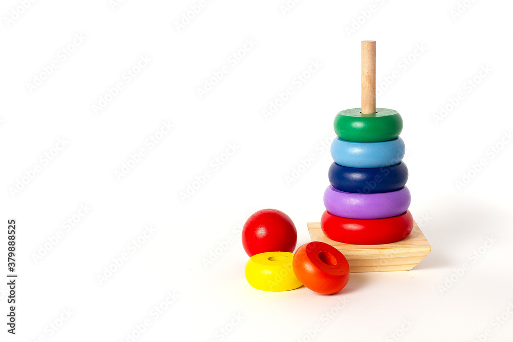 toy pyramid, wooden, multi - colored rings, on a white background toy pyramid, wooden, multi - colored rings, on a white background