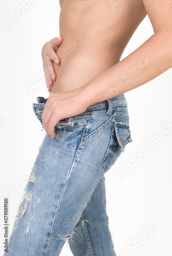 Female hips in tight jeans on a white background