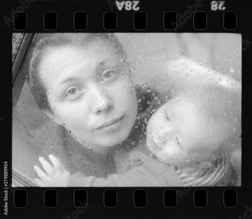 woman with a child looking through car window photo