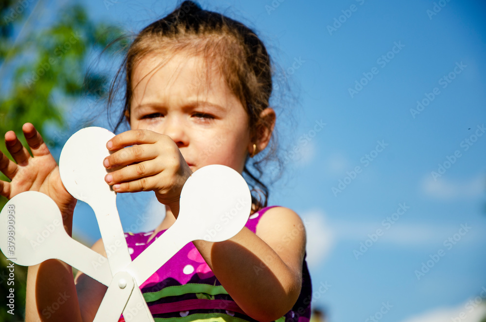 The child teaches the letters preparation for school. A little girl with letters in her hands is preparing for the educational process at school. Social advertising of early childhood development