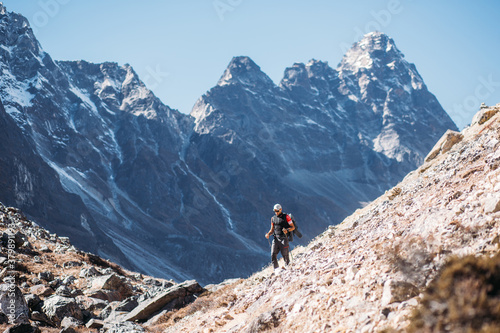 Man hiking on the way to mountain peak photo