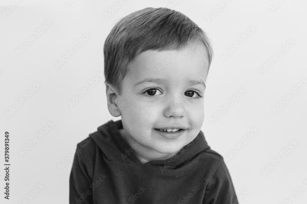 Black and white portrait of a cute young boy looking into the camera Black and white portrait of a cute young boy looking into the camera