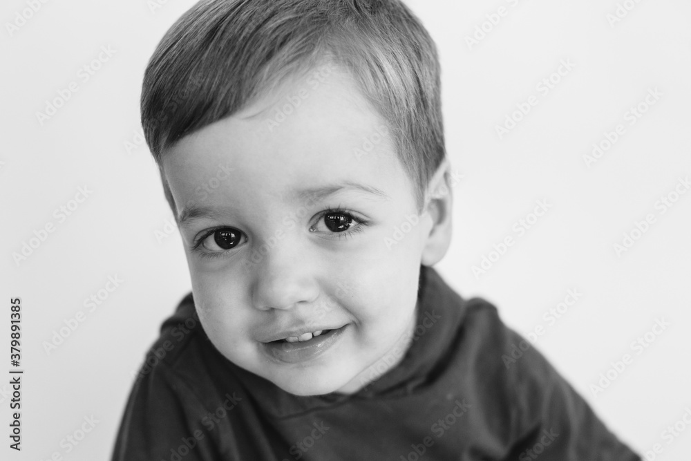 Black and white portrait of a cute young boy looking into the camera Black and white portrait of a cute young boy looking into the camera