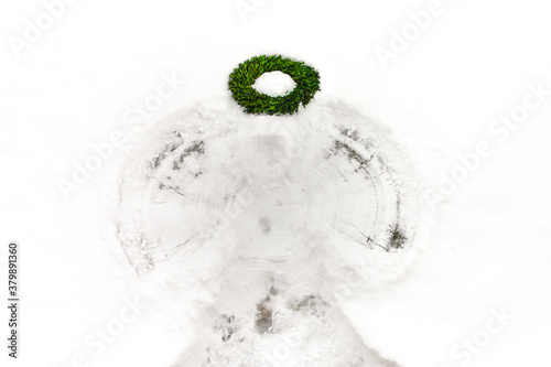 A snow angel with boxwood wreath used as a halo