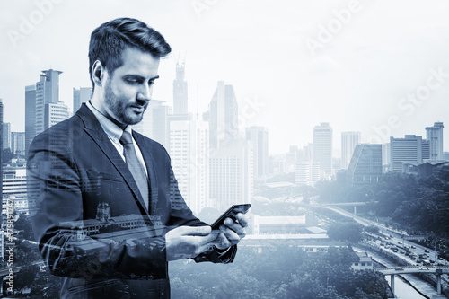 Photography Prosperous European businessman in suit texting phone the details of corporate meeting