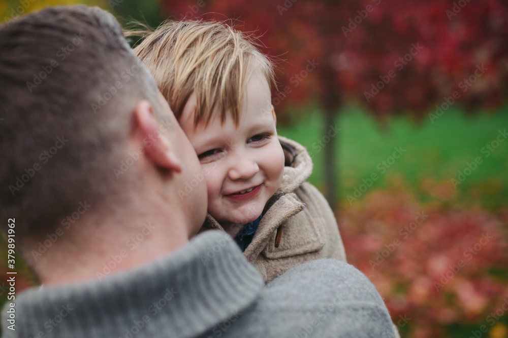 Dad and son bonding together in backyard Dad and son bonding together in backyard