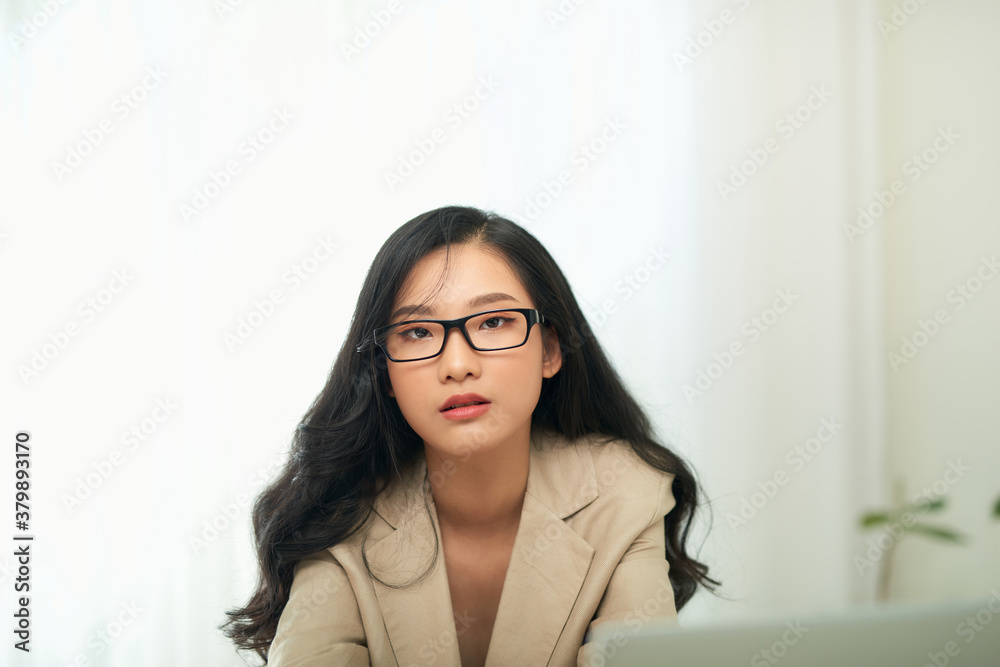 Bored young woman sit at home office table look in distance unable to work at laptop,