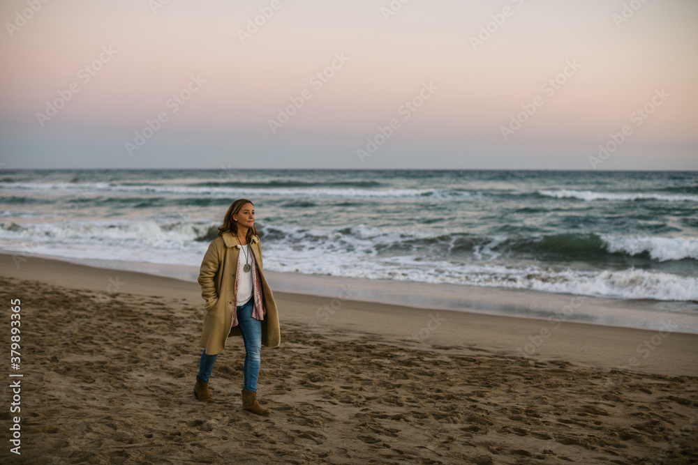 Woman relaxing walking on the beach in autumn. Woman relaxing walking on the beach in autumn.