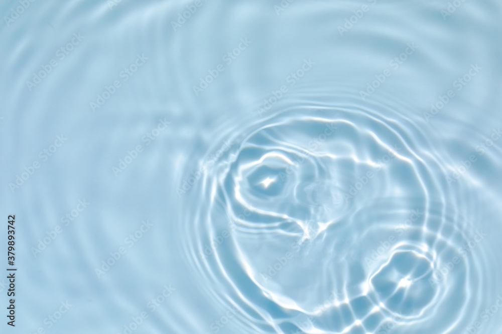 de-focused. Blurred transparent blue colored clear calm water surface texture with splashes and bubbles. Trendy abstract nature background. Water waves in sunlight with copy space. de-focused. Blurred transparent blue colored clear calm water surface texture with splashes and bubbles. Trendy abstract nature background. Water waves in sunlight with copy space.