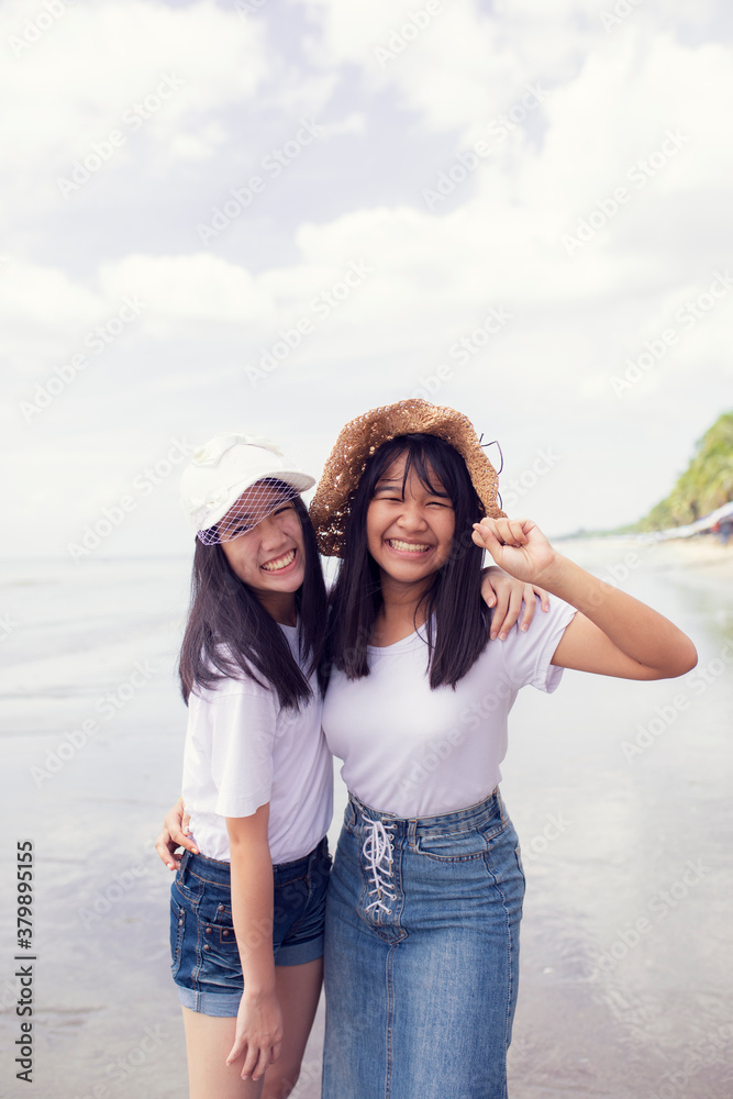two asian teenager happiness on sea beach