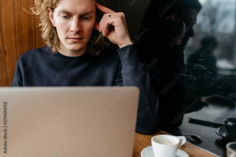 Man sitting at a table and working on a computer Man sitting at a table and working on a computer