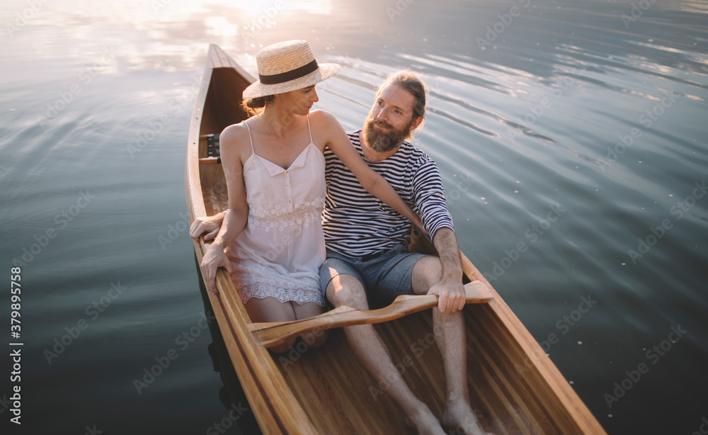 Man and woman enjoy boat ride at sunset