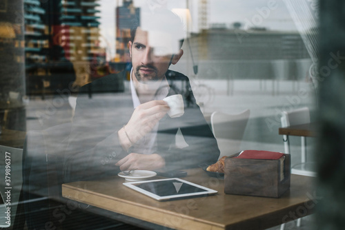 Young businessman sititng in a cafe photo