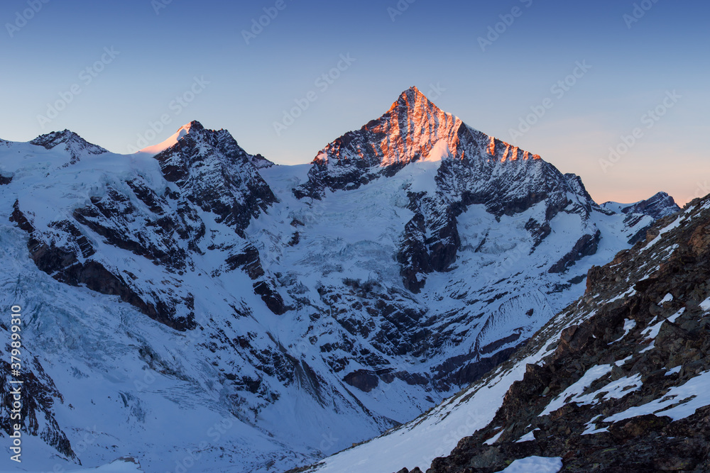 View of snow covered landscape with Dent Blanche mountains and Weisshorn mountain in the Swiss Alps near Zermatt. Panorama of the Weisshorn and surrounding mountains in Switzerland. Beautiful morning 