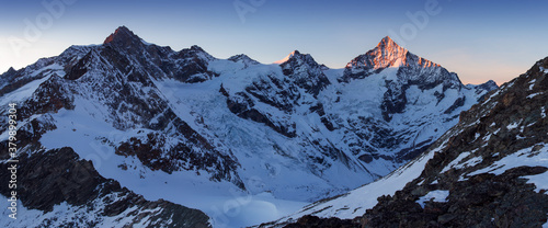 View of snow covered landscape with Dent Blanche mountains and Weisshorn mountain in the Swiss Alps near Zermatt. Panorama of the Weisshorn and surrounding mountains in Switzerland. Beautiful morning 