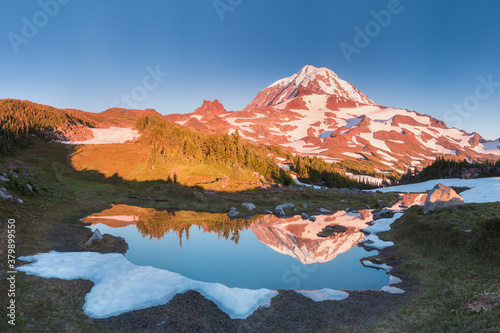 Mount Rainier towers over the surrounding mountains sitting at an elevation of 14,411 ft. It is considered to be one of the world's most dangerous volcanoes. Wonderful Nature landscape. Popular place