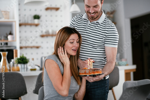 Wife's birthday. Husband surprise his wife with birthday cake.