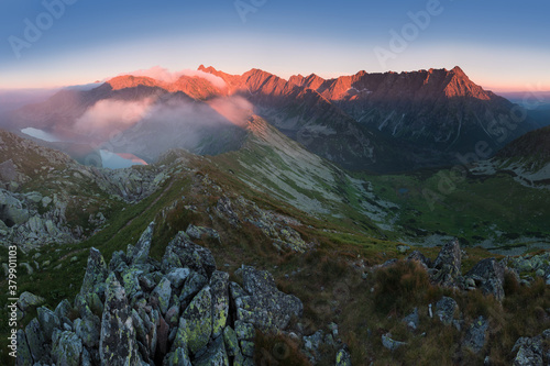 Fototapeta Naklejka Na Ścianę i Meble -  Scenic image of Fairytale mountains during sunset. The sunrise over a mountain in park High Tatras. Slovakia, Europe. Wonderful Autumn landscape. Picturesque view of nature Amazing natural Background