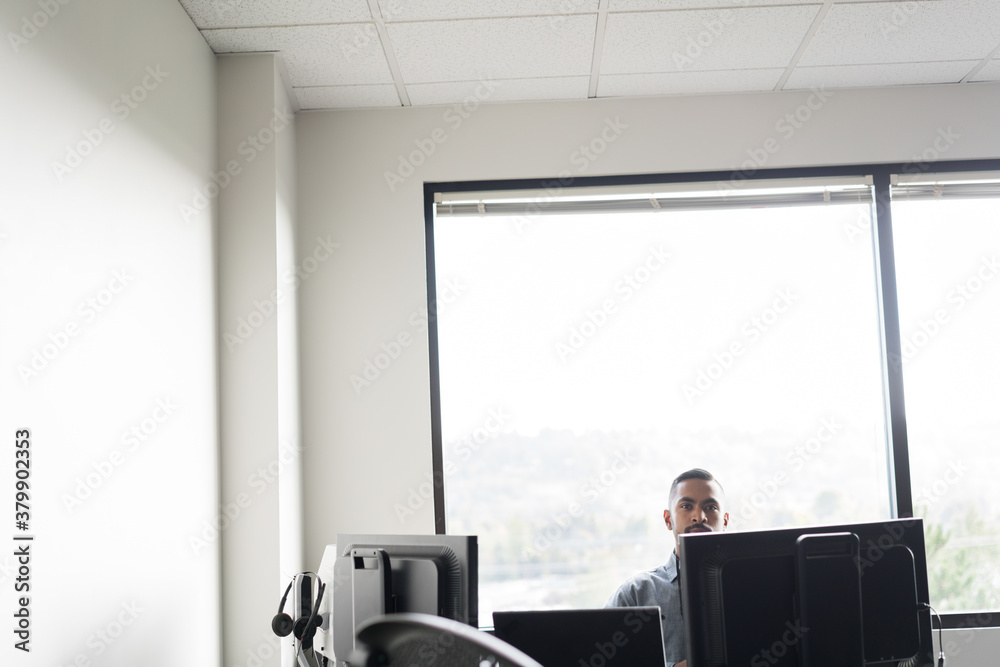 Man sitting at computer in office Man sitting at computer in office