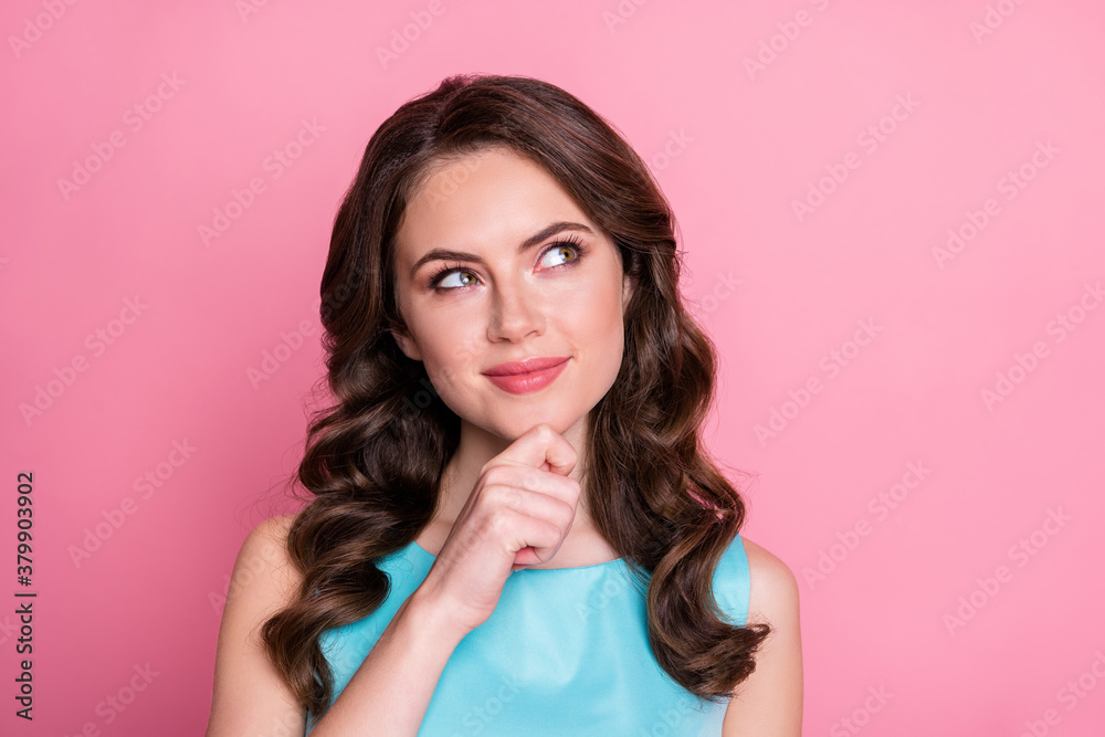 Closeup photo of attractive curly lady look interested side empty space thinking creative idea clever arm on chin wear blue teal dress isolated pastel pink color background Closeup photo of attractive curly lady look interested side empty space thinking creative idea clever arm on chin wear blue teal dress isolated pastel pink color background
