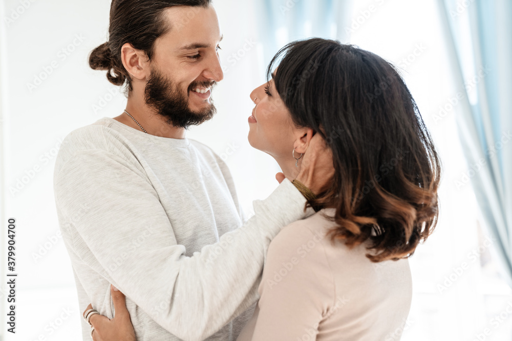 Image of romantic joyful couple smiling and hugging while standing Image of romantic joyful couple smiling and hugging while standing