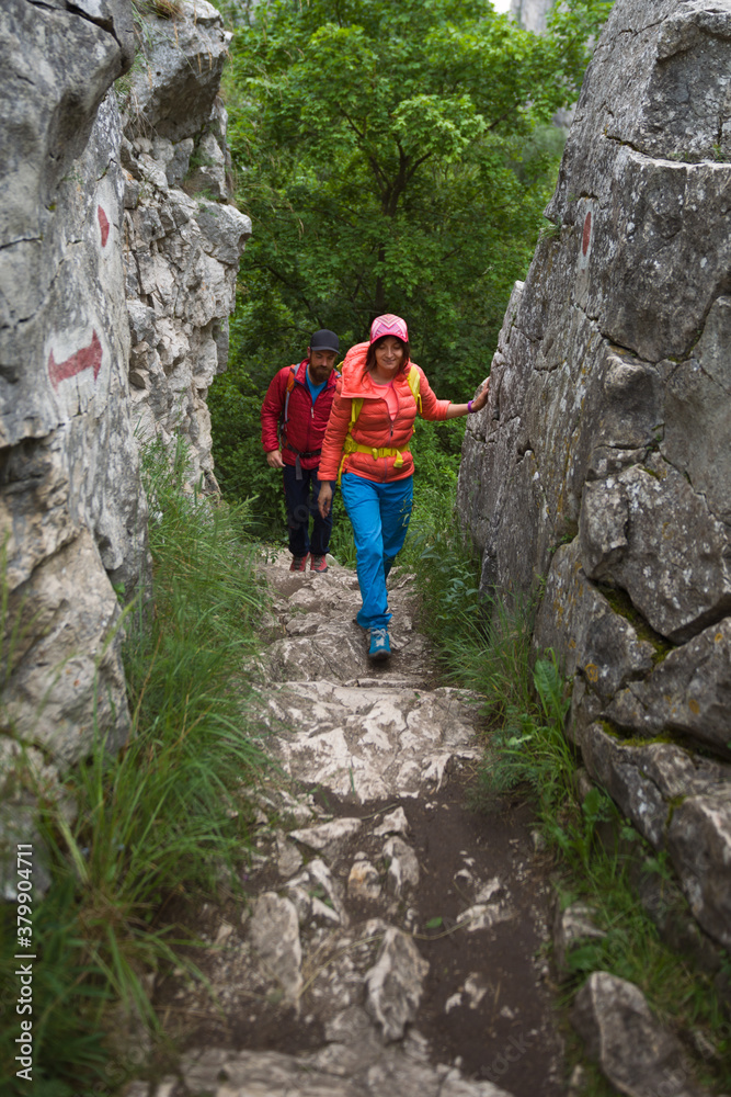 Couple of hikers following a mountain trail Couple of hikers following a mountain trail