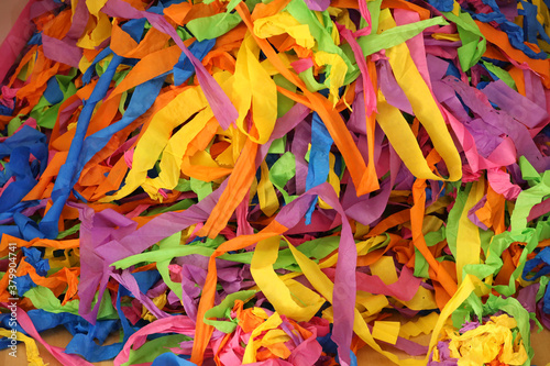 Large mass of brightly colored coloured paper streamers. Backgound of colours clours shapes line and pattern. Abstract creative banner. photo