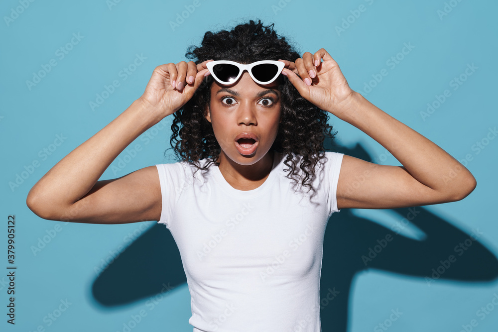 Image of shocked african american woman expressing surprise at camera