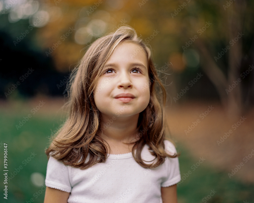 Beautiful young girl looking up at the sky Beautiful young girl looking up at the sky