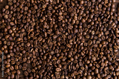 Coffee cup with coffee bag on wooden table. View from top Roasted coffee beans 