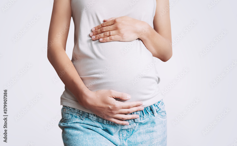 Pregnant woman holds hands on belly. Photo of pregnancy. Pregnant woman holds hands on belly. Photo of pregnancy.