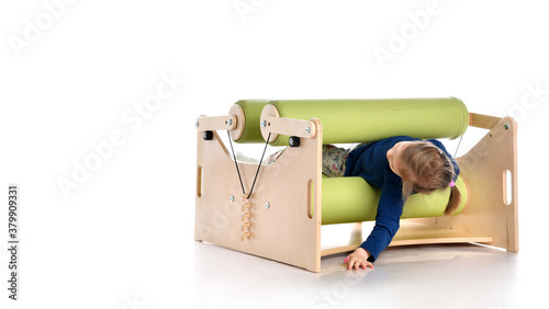 Smiling little child demonstrating usage of exercise set for persons with locomotor disorder, isolated on white, copy space photo