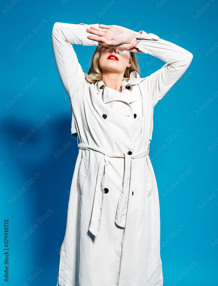 Woman with eyes closed wearing trench Woman with eyes closed wearing trench