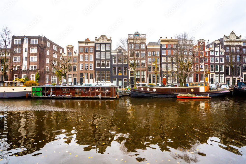 Fototapeta premium Nice buildings around canal in Amsterdam , Netherlands - 26 November