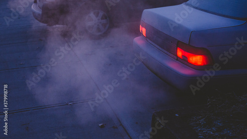 Car exhaust in early, frosty morning